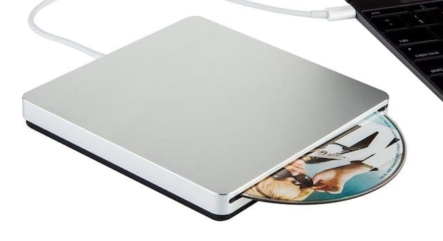 External CD drive connected to MacBook.