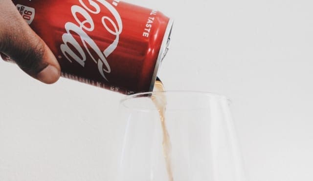 Coca Cola pouring into a glass