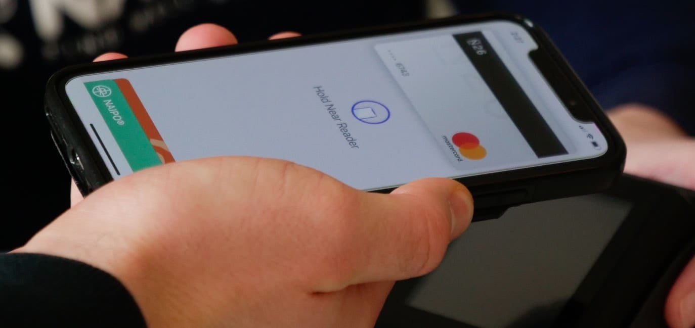 Photo of a person paying via Apple Pay