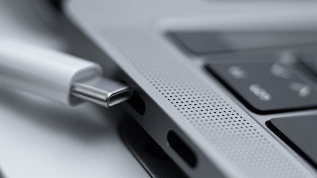 USB-C cable inserting into MacBook port