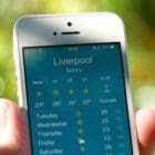 photo of the weather app on a iphone with someone holding it
